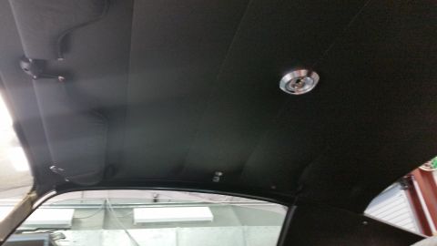 1970 Chevrolet Camaro - The interior ceiling of a vehicle shows a dome light and sun visors, with a Supermotors.net watermark.