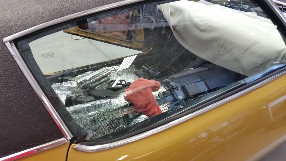 1970 Chevrolet Camaro interior showing sound deadening material on the floor and a red cloth on the passenger seat