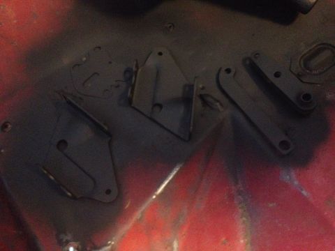 1978 Ford Bronco - Several metal brake components are visible, painted black on a red background.