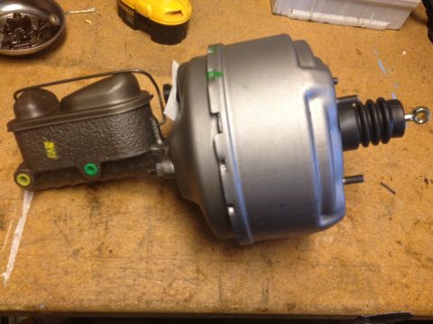 1978 Ford Bronco - Brake booster and master cylinder assembly shown on a wooden surface.