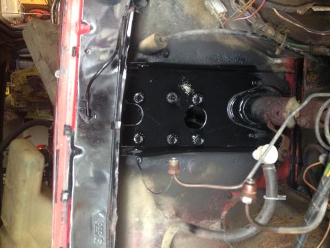 1978 Ford Bronco - Detail of a vehicle's brake system components, showing a black mounting plate and associated hardware.