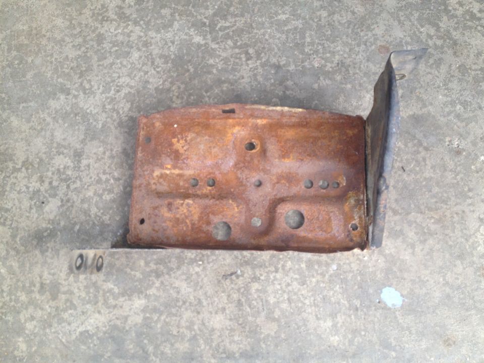 Rusted metal bracket with stamped markings '010'
