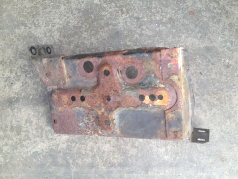 1978 Ford Bronco - This heavily rusted metal bracket shows significant corrosion and wear.