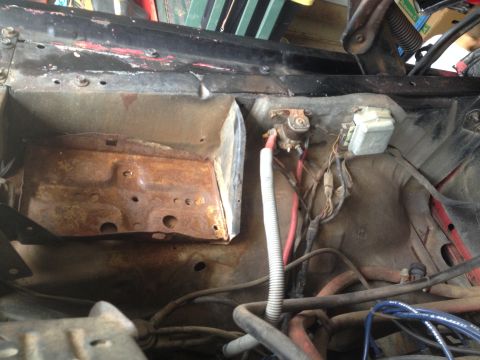 1978 Ford Bronco - Close-up view of a corroded engine bay showing electrical components and hoses.