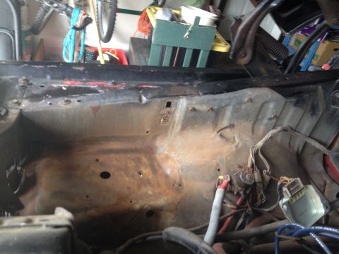 1978 Ford Bronco - View of a rusty engine bay with visible wiring and components.