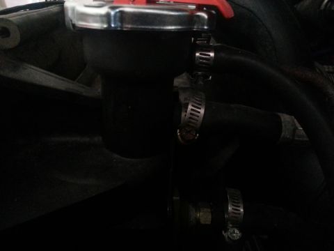 1994 Ford Bronco - Close-up of a radiator cap and hoses, likely from an engine bay.