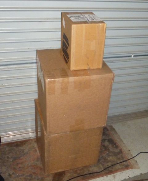 1964 Mercury Monterey - Cardboard boxes are stacked in front of a closed garage door.
