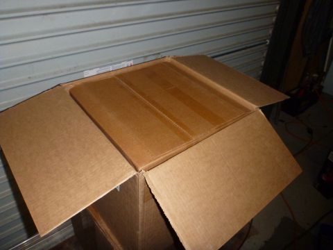 1964 Mercury Monterey - An open cardboard box sits in a garage, with a corrugated metal door in the background.