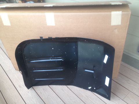 1978 Ford Bronco - A black fender part, possibly for a vehicle, is shown in front of a large cardboard box. The part has horizontal vents and white tape.