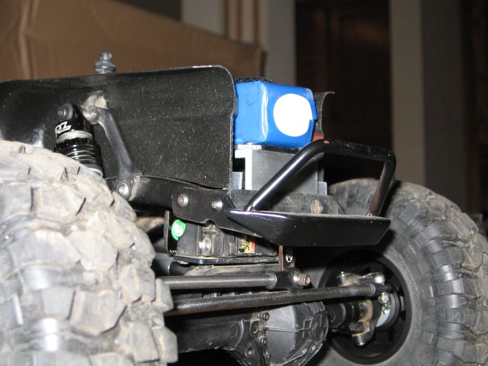 RC vehicle chassis with blue battery pack and black bumper