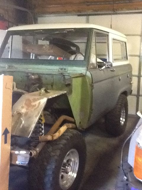 1988 Suzuki Samurai - This Ford Bronco is in a garage, appearing to be in the process of restoration.