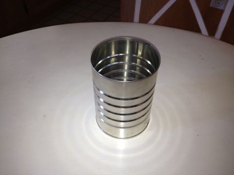 1961 International Scout 800 - A metal can sits on a table, its ribbed exterior reflecting light.