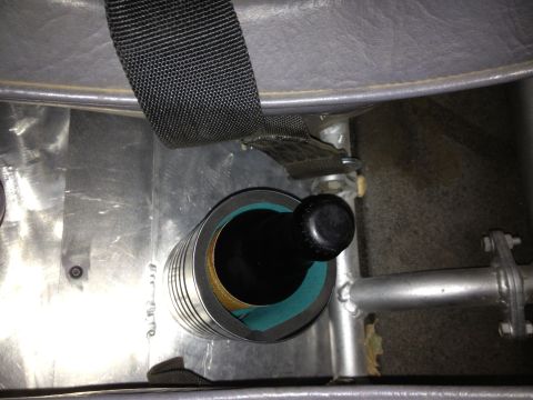 1961 International Scout 800 - Close-up of a custom cup holder, possibly in a vehicle, holding a bottle.