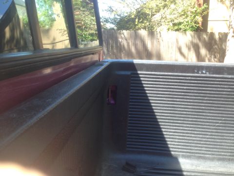 1992 Ford F-150 - Interior view of a 1992 Ford F-150 truck bed, showing the ribbed floor and red side panel.