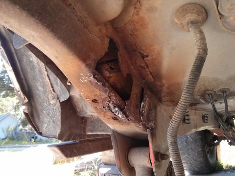 1986 Ford Bronco - Severe rust damage is visible on the vehicle's frame, indicating significant structural compromise.