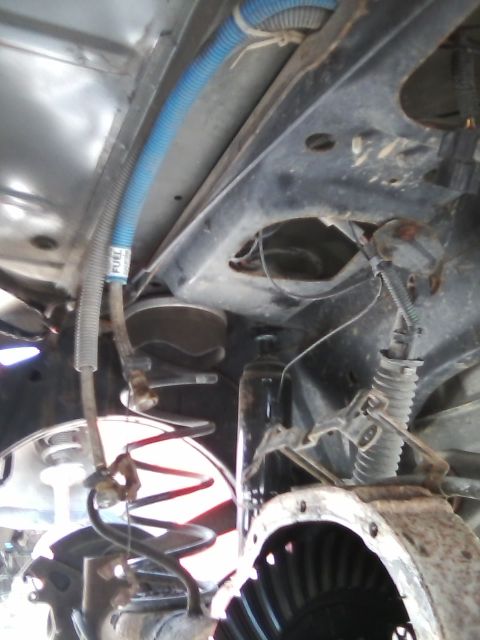 1999 Mercury Grand Marquis - Close-up of vehicle undercarriage components including suspension and differential.