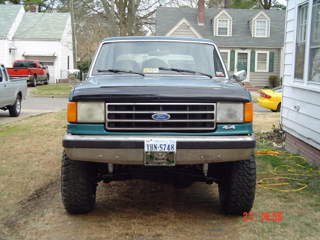 Teal 1989 Ford Bronco front view with black hood and chrome grille