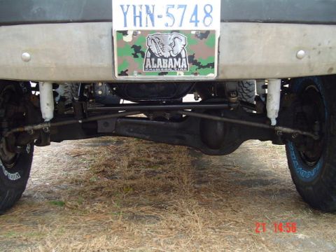1989 Ford Bronco - Close-up view of the rear axle and suspension components of a vehicle.