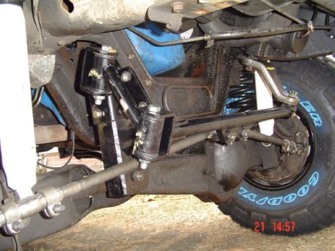 1989 Ford Bronco - Close-up of the vehicle's front suspension components and a tire with visible text.