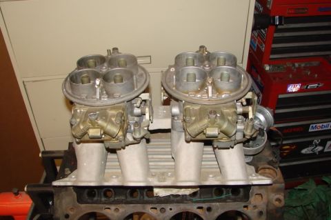 1972 Ford Ranchero - Close-up of dual carburetors on an engine block, with a red toolbox visible behind.