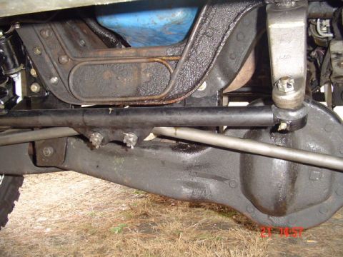 1989 Ford Bronco - Close-up view of a vehicle's undercarriage, revealing mechanical parts and suspension system.