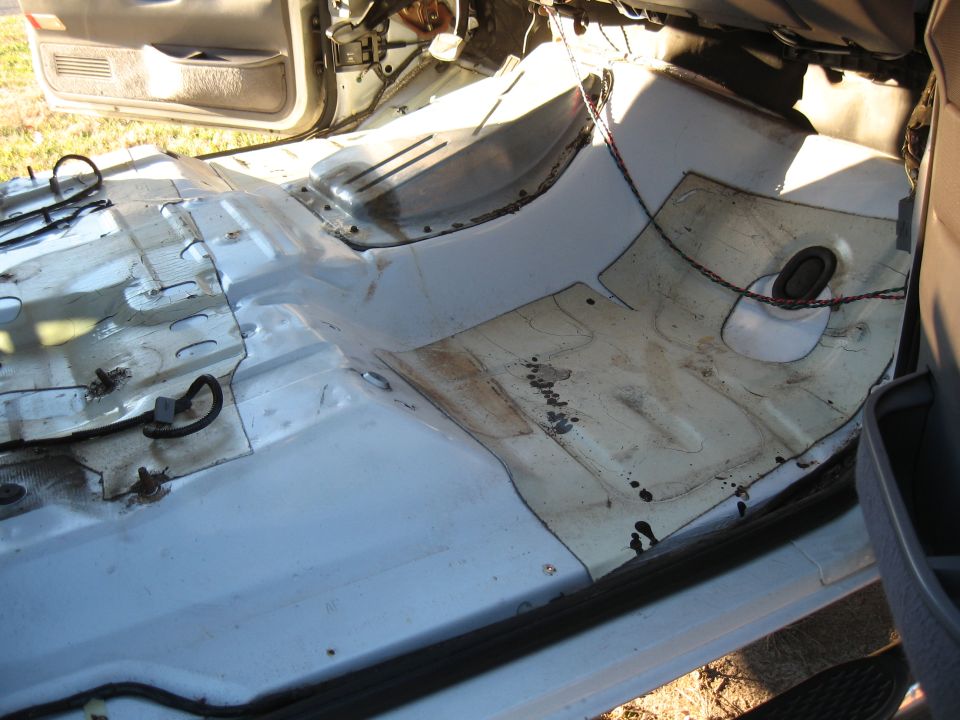 Interior floor panels of a vehicle with exposed metal and wiring
