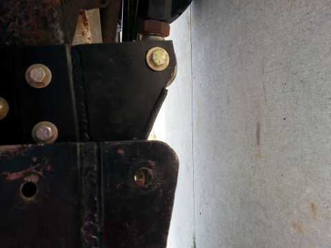 1996 Ford Bronco - Detail of vehicle frame and suspension components, showing bolted metal brackets.