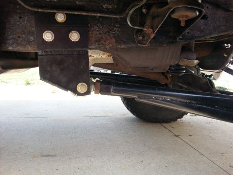 1996 Ford Bronco - This photo shows the undercarriage of a vehicle, focusing on suspension components and a custom-mounted bracket.