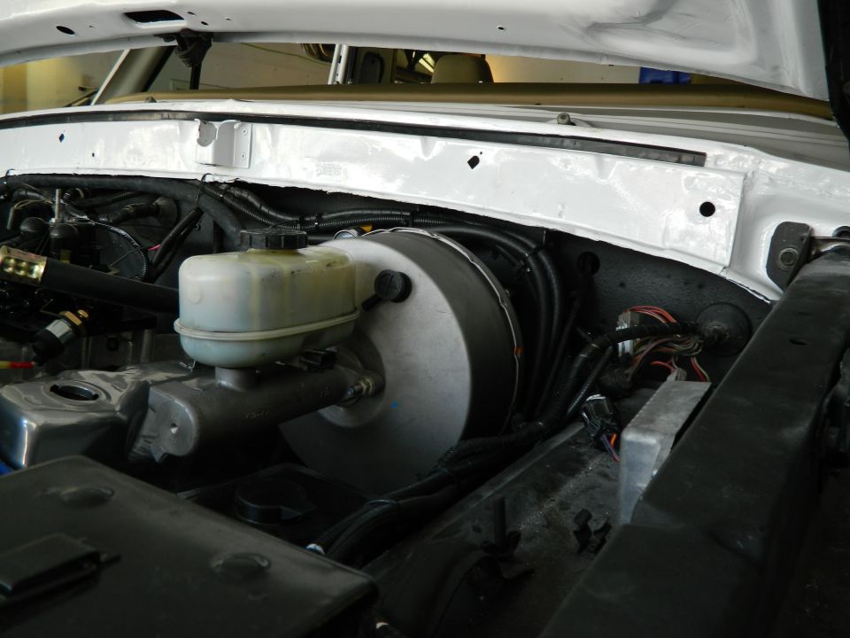 Brake booster and master cylinder assembly under white hood