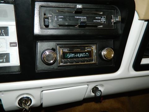 1979 Ford Bronco - The dashboard of a 1979 Ford Bronco shows the radio, climate controls, and part of the instrument cluster.
