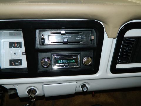 1979 Ford Bronco - The interior of a 1979 Ford Bronco, its dashboard with radio and climate controls.