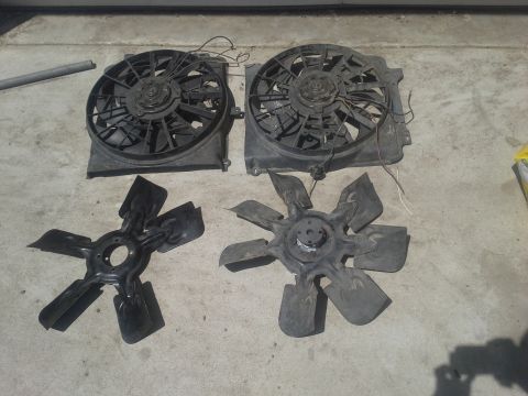 1991 Ford F-250 - Radiator fan assemblies and fan blades are displayed on a concrete floor.