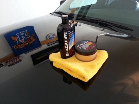 2003 Mercury Marauder - Car detailing products are arranged on the hood of a dark-colored vehicle.