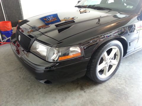 2003 Mercury Marauder - Front corner view of a black 2003 Mercury Marauder, highlighting its distinctive grille and chrome wheels.