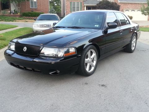 2003 Mercury Marauder - Black 2003 Mercury Marauder parked on a suburban street with another car in the background.
