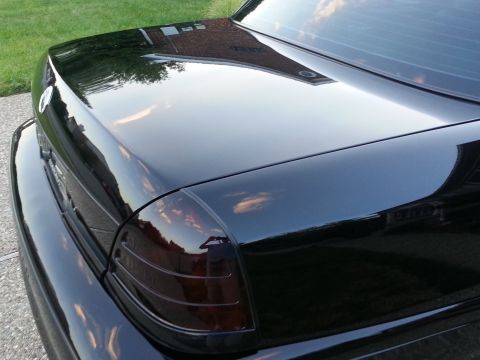 2003 Mercury Marauder - Rear view of a black 2003 Mercury Marauder, showing the trunk and tinted taillights.