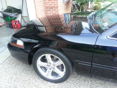 2003 Mercury Marauder - A black 2003 Mercury Marauder is parked in front of a brick garage.