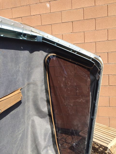 1995 Ford Bronco - Close-up of a soft top window frame, showing the clear plastic and frame structure.