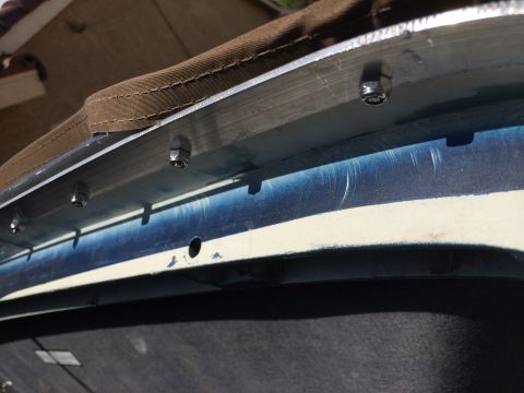 1995 Ford Bronco - Close-up of the mounting hardware for a soft top on a vehicle.