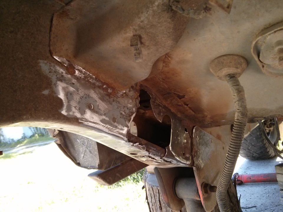 rusted frame damage on vehicle undercarriage