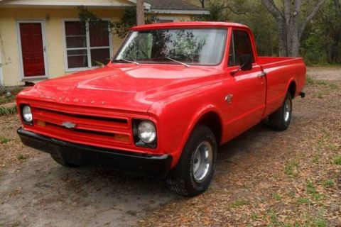 1999 Ford Ranger - This red Chevrolet C10 pickup truck is parked outside a house.