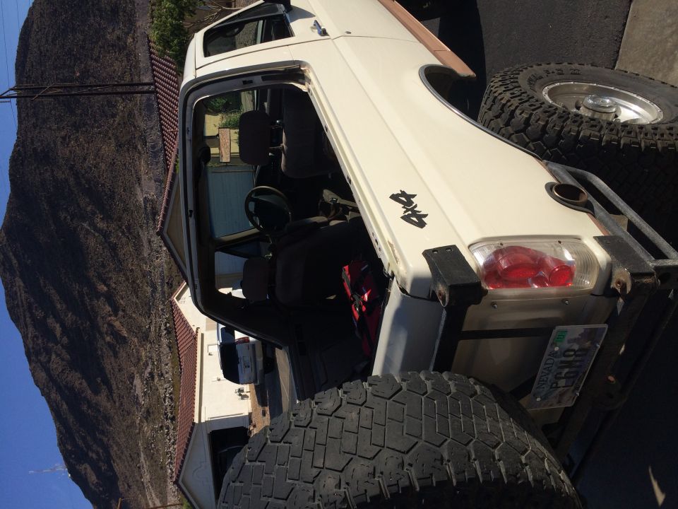 White 1995 Ford Bronco 4x4 with off-road tires and soft top removed