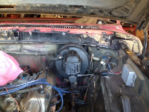 1978 Ford Bronco - Underside view of the brake booster and master cylinder assembly within the engine compartment.