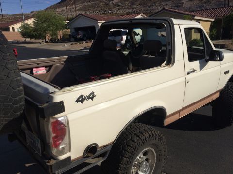 1995 Ford Bronco - This 1995 Ford Bronco is shown with its soft top removed, revealing the interior and cargo area.