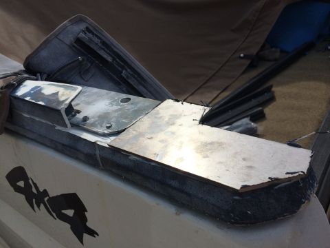 1995 Ford Bronco - A close-up view shows custom metal fabrication being attached to the exterior of a vehicle.