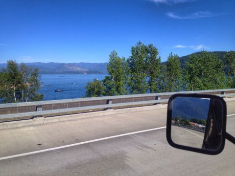 2005 Jeep Wrangler - A view from a vehicle's side mirror captures a scenic landscape with a lake and mountains under a clear blue sky.