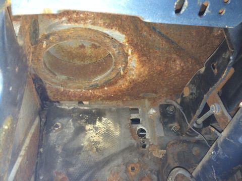 1964 Ford Fairlane - This heavily rusted part of a vehicle shows significant corrosion and wear, obscuring any specific identifying features.