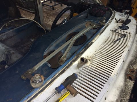 1964 Ford Fairlane - Close-up view of the windshield wiper mechanism and dashboard area of a vehicle in a state of deconstruction.
