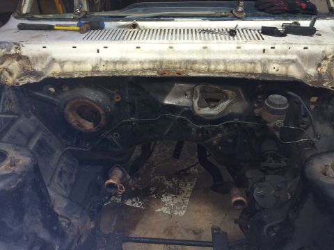 1964 Ford Fairlane - Tools are laid out on the cowl panel of a car undergoing deconstruction.