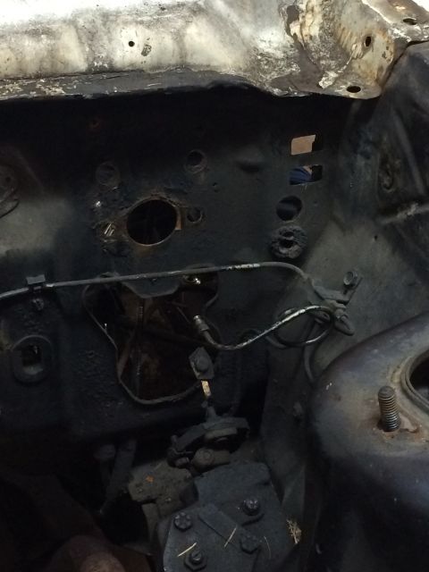 1964 Ford Fairlane - The engine bay of a 1964 Ford Fairlane, with visible firewall and steering mechanism.